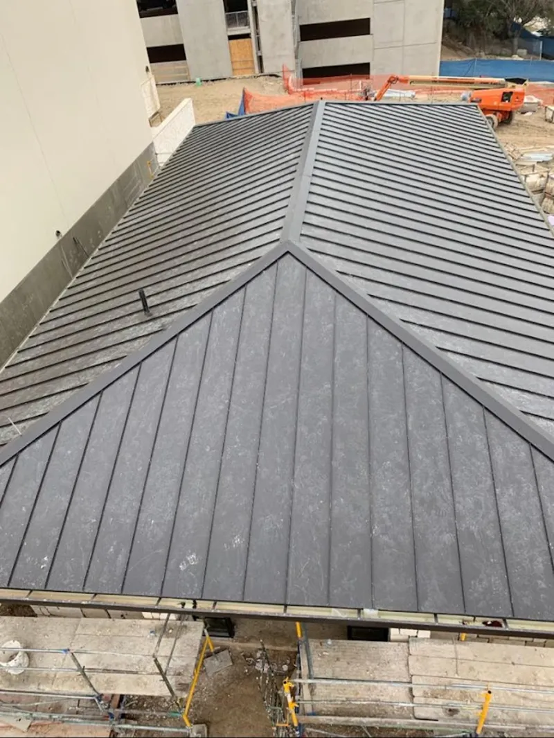 Commercial metal roof construction with crane equipment in Palm Desert